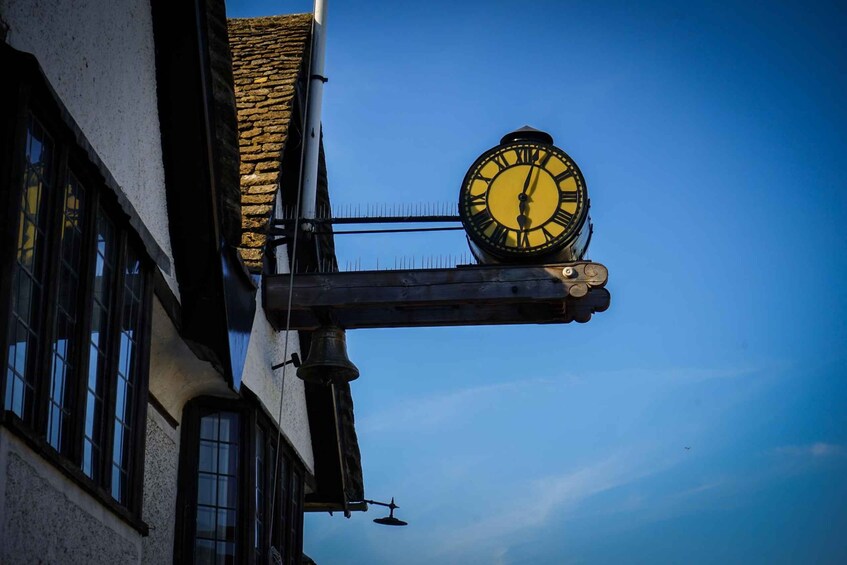 A clock mounted on a building with a clear blue sky in the background. 4