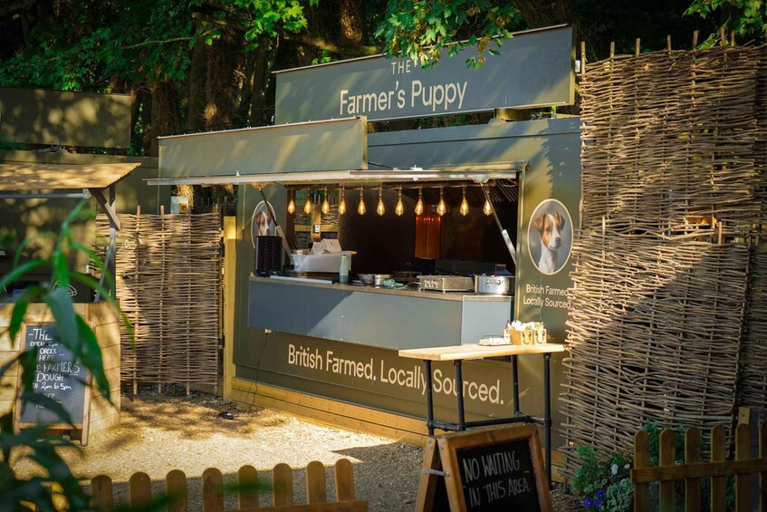 A food stall named 'Farmer's Puppy' with a sign stating 'British Farmed, Locally Sourced.' 1