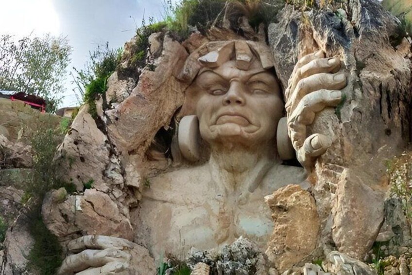 A rock formation with a carved face. 2