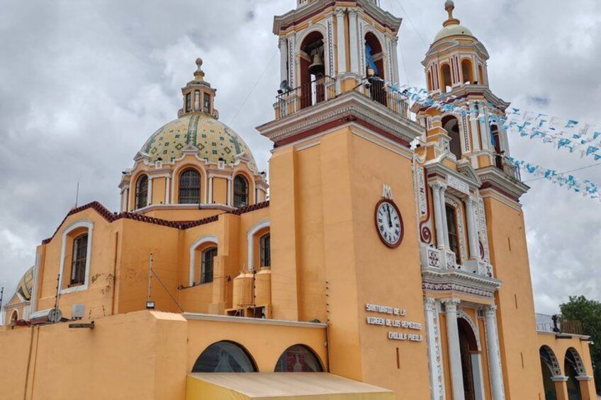 A church with a clock, domes, and bell towers. 4