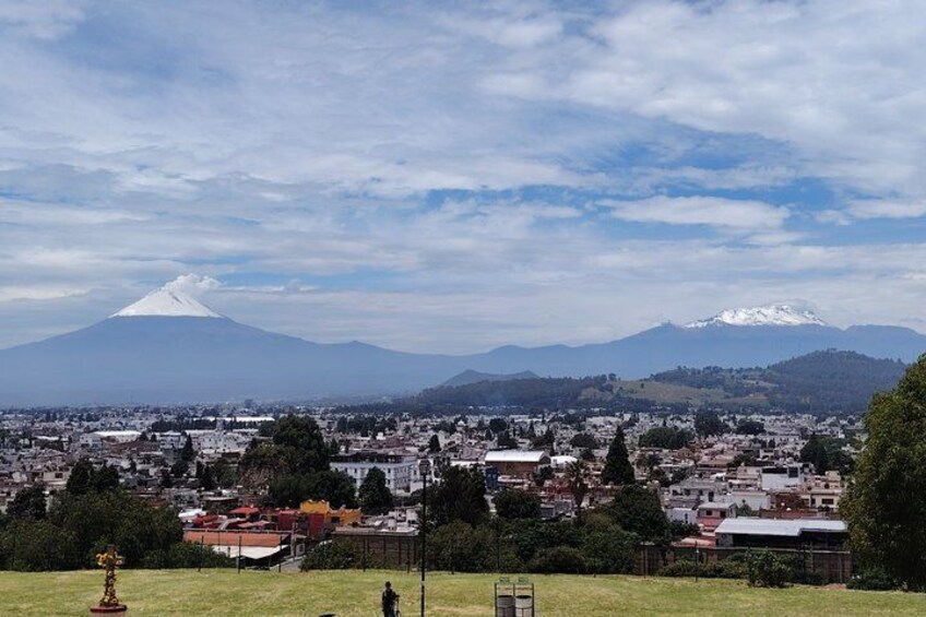 A cityscape with a prominent mountain in the background. 5