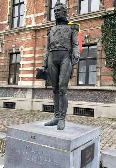 Eine Statue einer historischen Persönlichkeit in Militäruniform, die auf einem Sockel mit einer Gedenktafel steht. 4