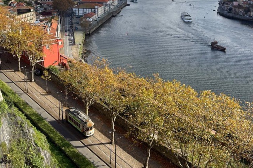 A river with boats, a tram, and a bridge. 4