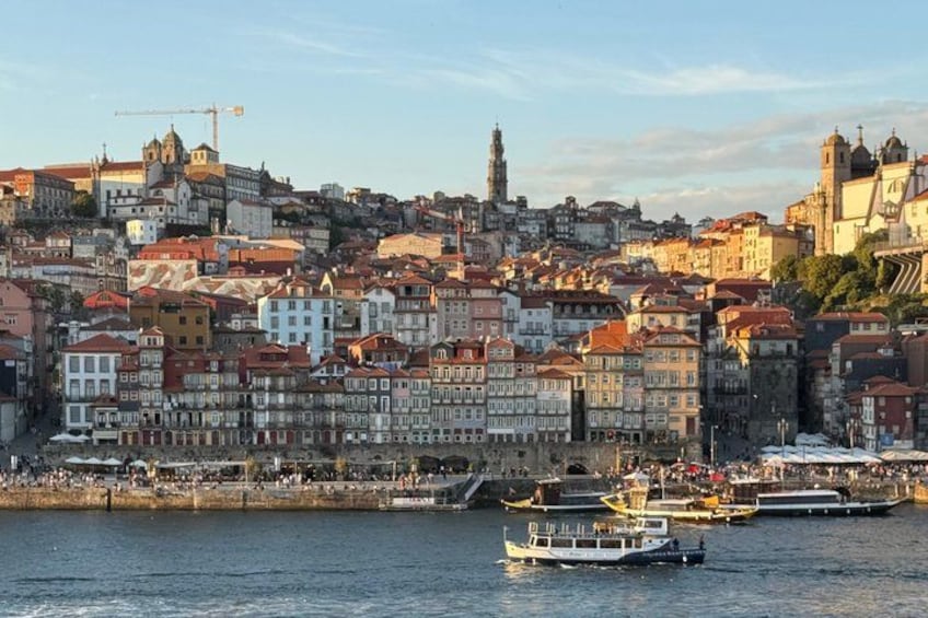 A cityscape with historic buildings, a river, and boats. 5