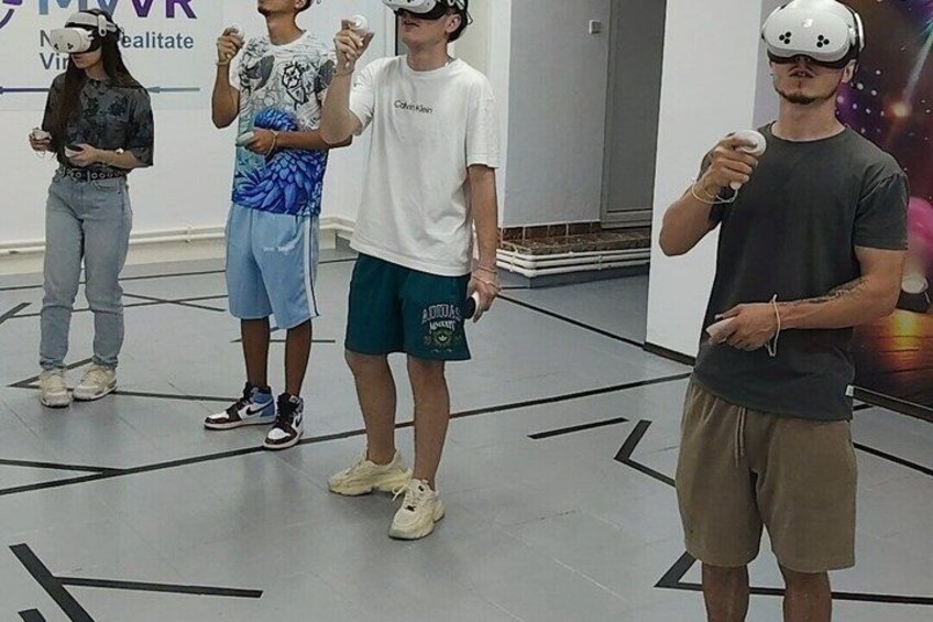 People using VR headsets in a room with a floor marked with black lines. 1