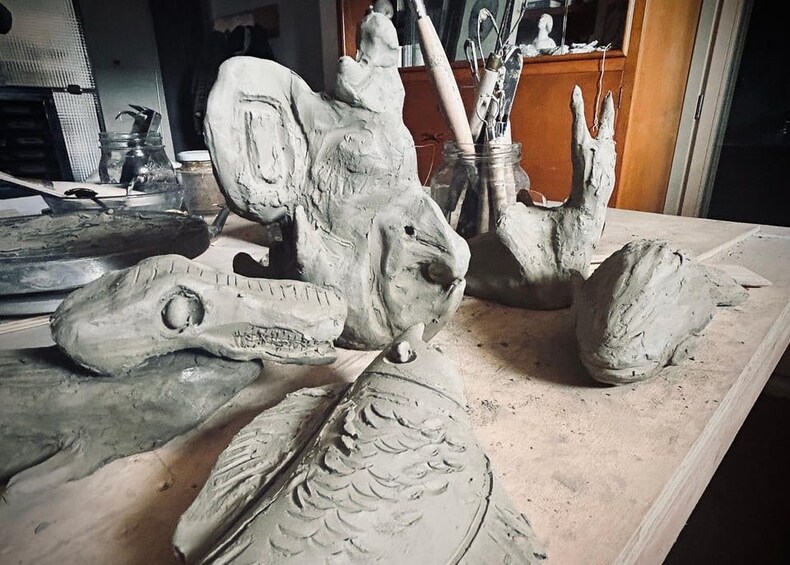 A pottery workshop with various clay sculptures and tools. 4