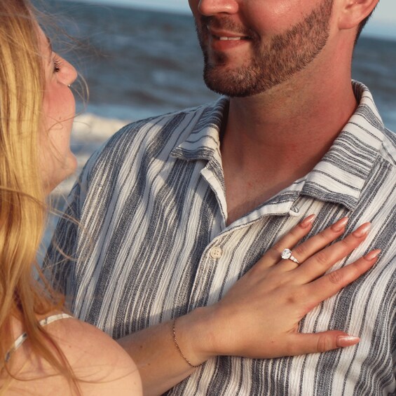 A person wearing a striped shirt with a ring on their finger. 4