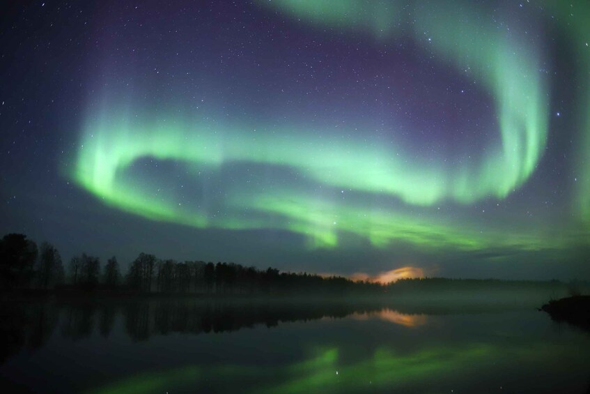 Revontulet tyynen järven yllä yöllä. 5