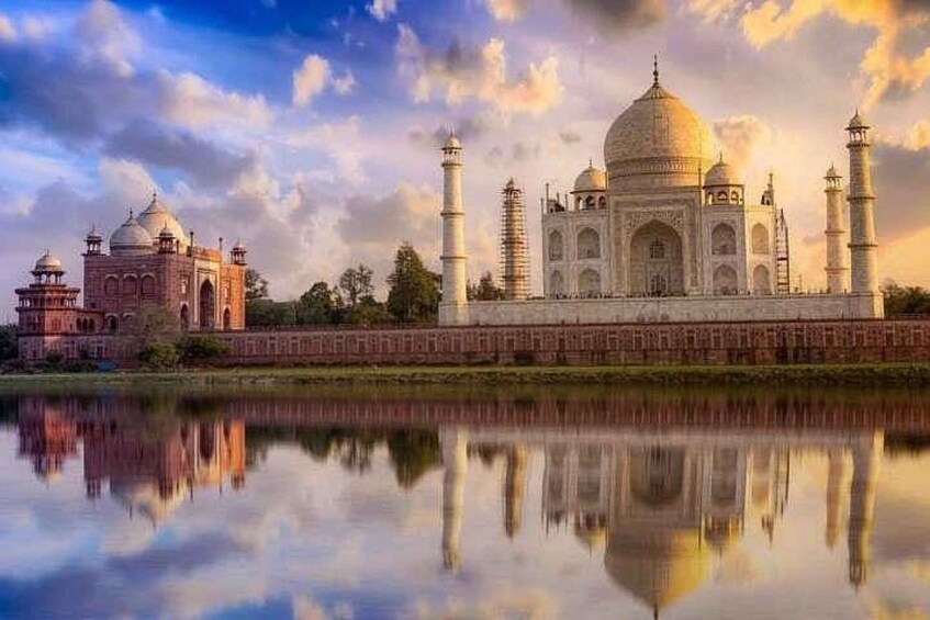 Das Taj Mahal mit seinem Spiegelbild im Wasser, umgeben von einem Garten und einem Fluss. 3