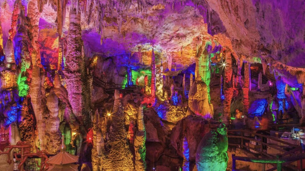 A cave with colorful lighting and stalactites. 4