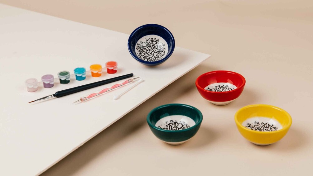 A paint set with brushes, paint pots, and bowls. 2