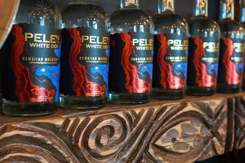 Bottles of Pele's White Dog Hawaiian Moonshine on a shelf. 4