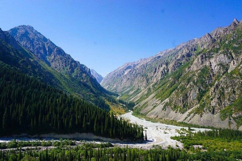 A mountainous landscape with a river flowing through a valley. 2