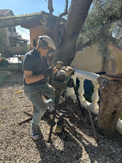 A person using a chainsaw to cut wood. 4