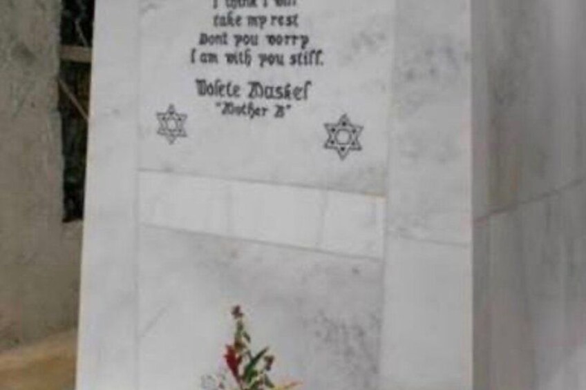 A gravestone with Hebrew inscriptions and Star of David symbols. 4