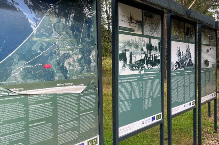 A series of informational signs with maps and historical photographs. 5