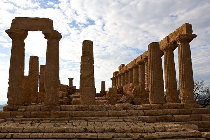 Ancient stone ruins with columns and a large archway. 4