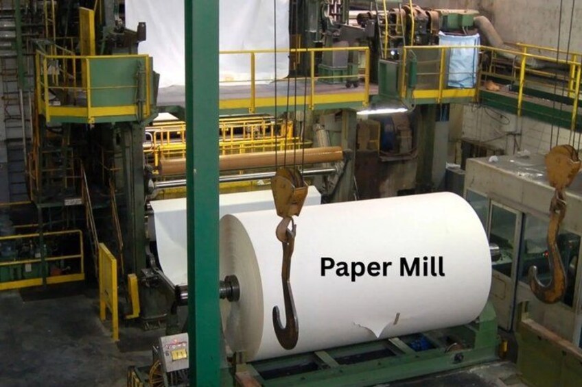 A paper mill with large rolls of paper being processed. 3