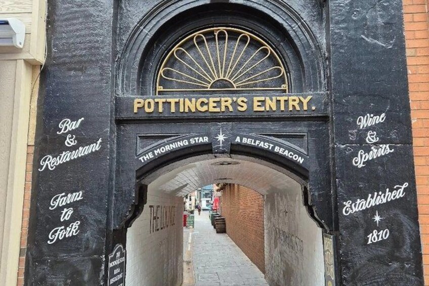 An entrance with a sign reading 'POTTINGER'S ENTRY.' 5