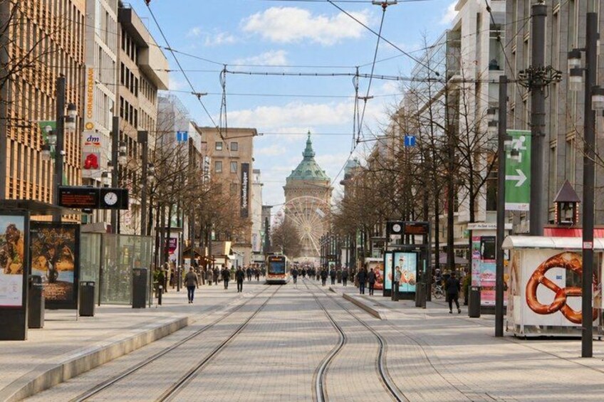 A tram line, buildings, and a distant green dome. 4