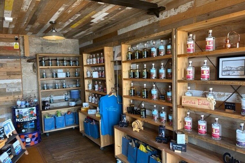 A liquor store with wooden shelves stocked with various bottles. 3