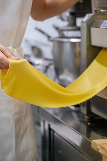 A person holding a yellow pastry bag. 2