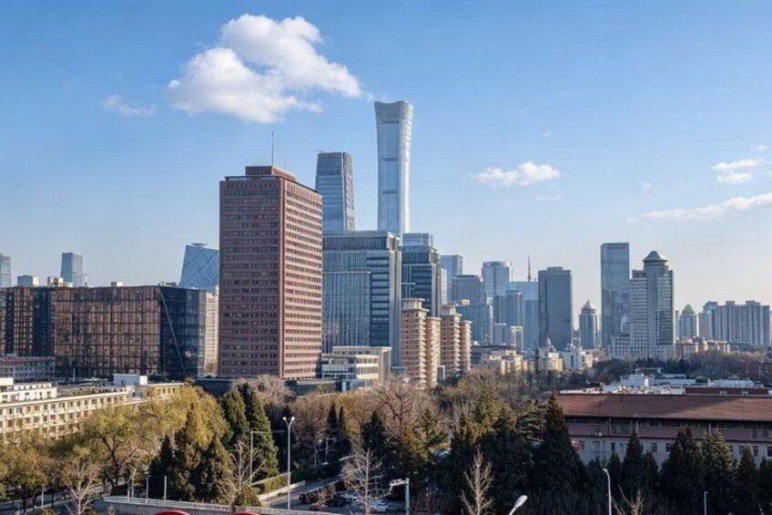 A city skyline with modern skyscrapers, a prominent tower, and a mix of residential and commercial buildings. 4