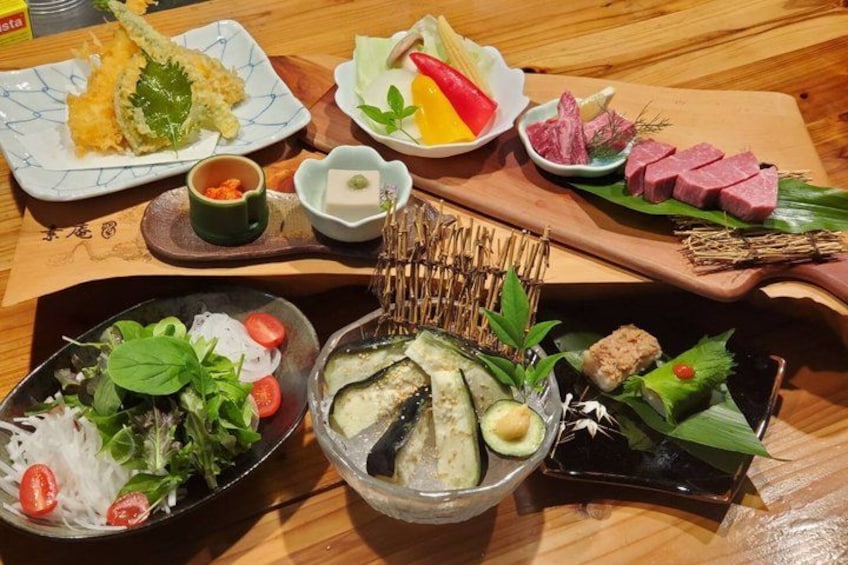 A variety of Japanese dishes including sushi, sashimi, and a salad. 4
