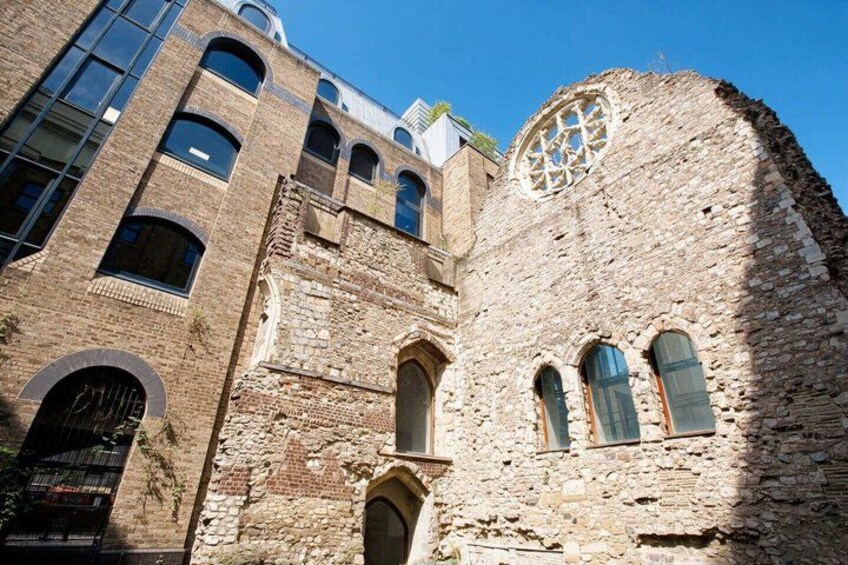 A historic building with arched windows and a large circular stained glass window. 3