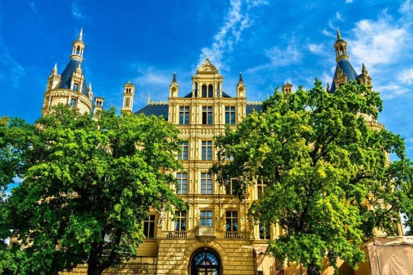 A historic building with ornate architecture, large windows, and multiple spires. 2