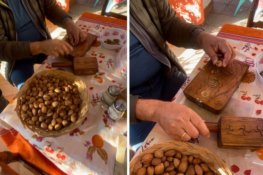 A person using a wooden mallet to crack nuts on a cutting board. 2