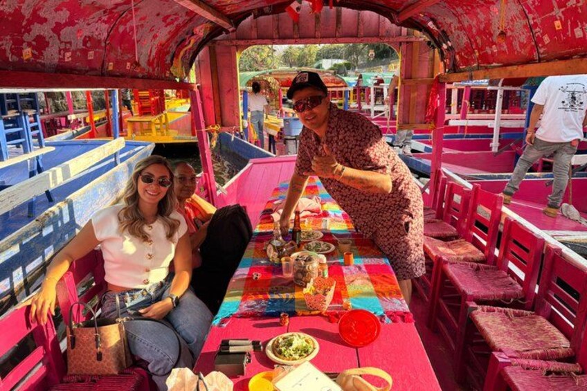A colorful boat with passengers dining. 4