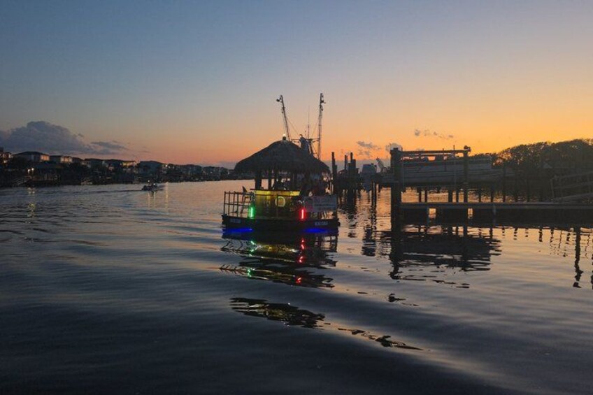 A boat docked at a pier with a sunset in the background. 5