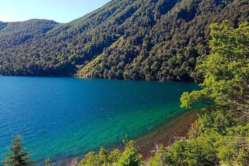 A lake surrounded by forested hills. 4