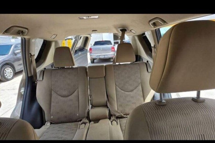 The interior of a car with three seats and a sunroof. 4