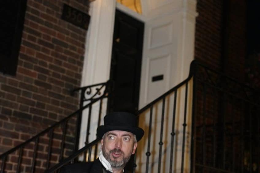 A person standing on a staircase with a brick building in the background. 3