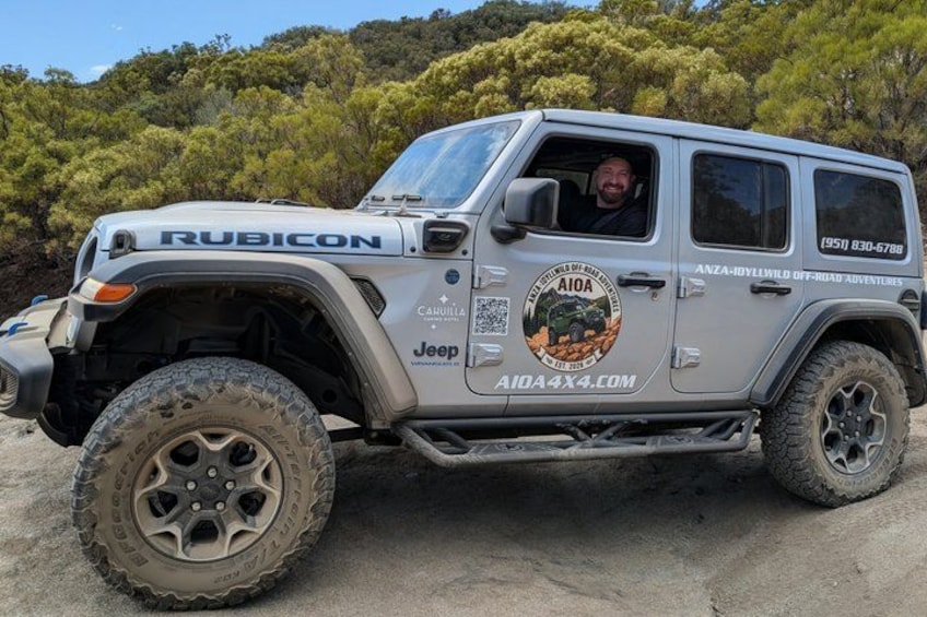 A Rubicon Jeep with off-road stickers and a rugged tire tread. 3
