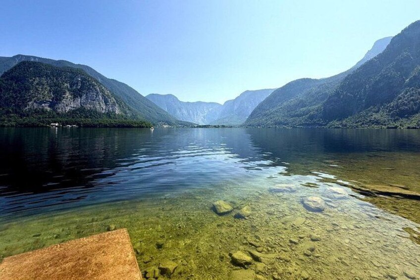 A calm lake with clear water, surrounded by mountains. 5