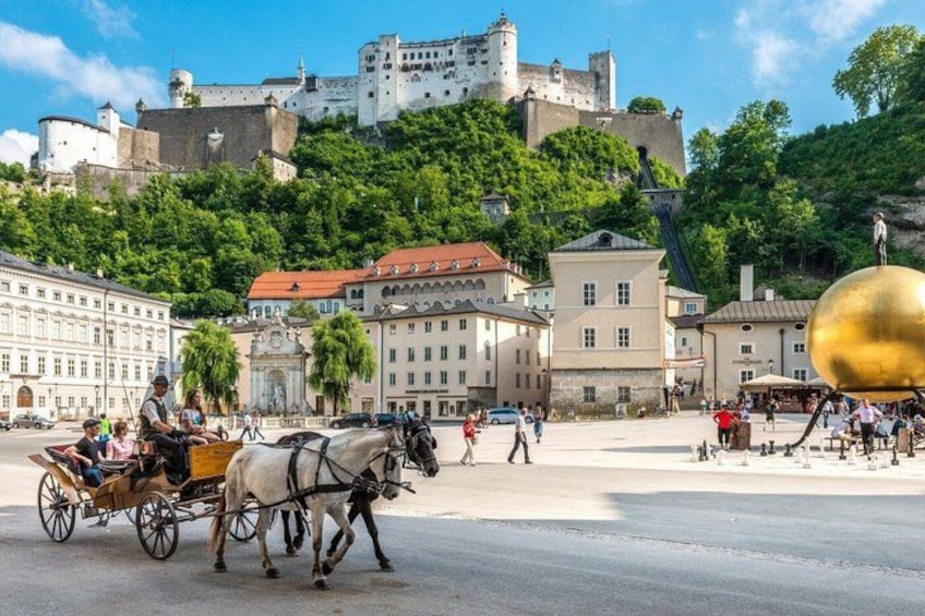 A horse-drawn carriage on a city street, historic buildings, and a castle on a hill. 4