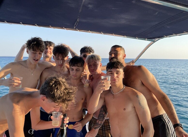 A group of people on a boat with a clear view of the ocean. 3