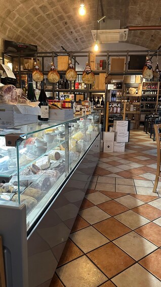 A deli counter with various cheeses and cured meats on display. 3