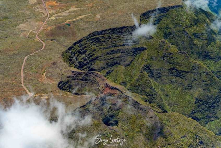 A mountainous landscape with a winding road and patches of greenery. 4
