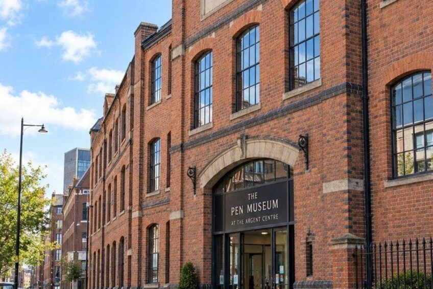A brick building with a sign reading 'The Pen Museum at the Ancient Centre.' 2