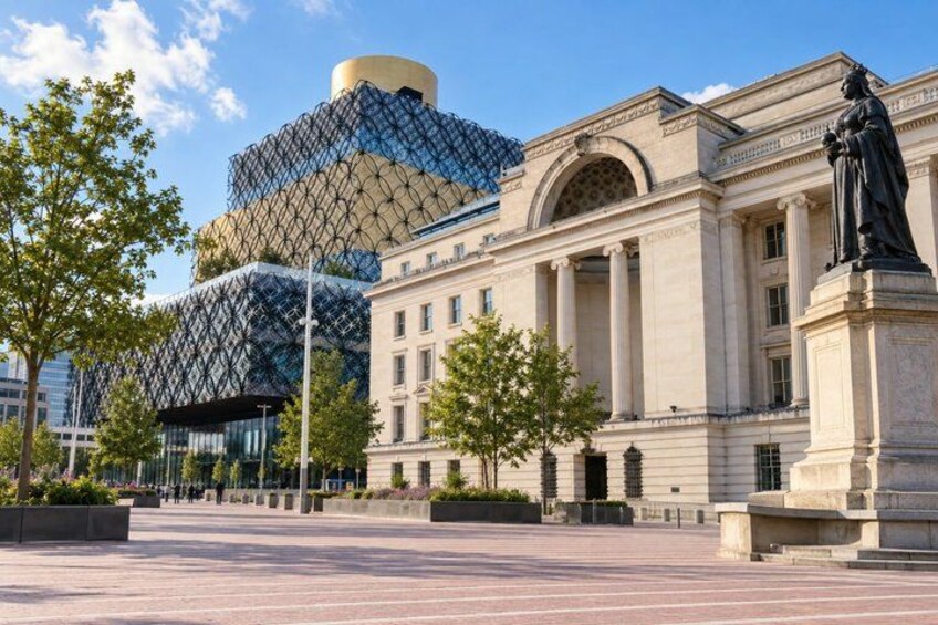 A modern building with a unique spherical structure, classical architecture, and a statue in a plaza. 1