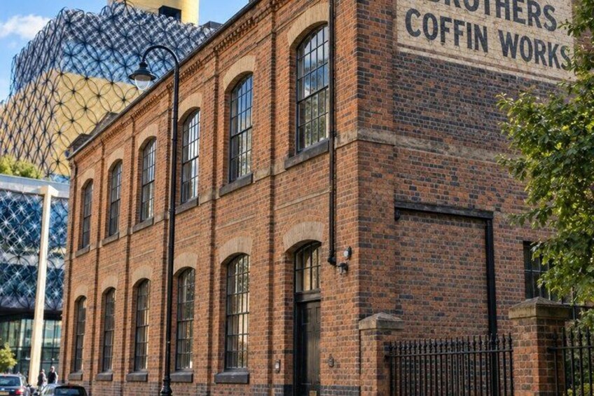 A brick building with large windows and a sign that reads 'Brothers Coffin Works.' 3