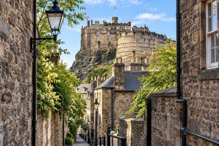 A stone street with a castle on a hill in the background. 3