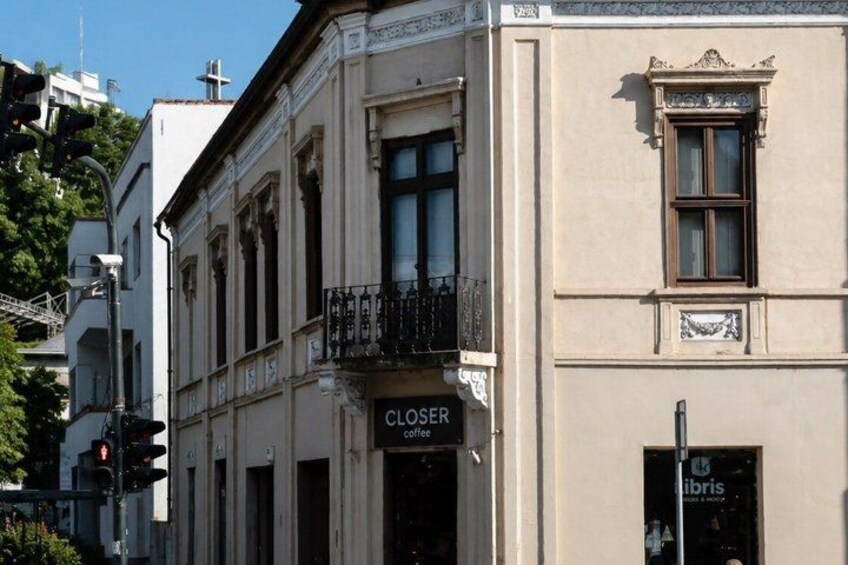 A building with a 'Closer Coffee' sign and a 'Libris' sign. 3