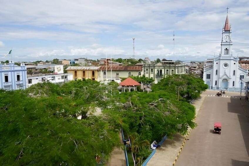 A cityscape with a prominent church, a road, and surrounding buildings. 5