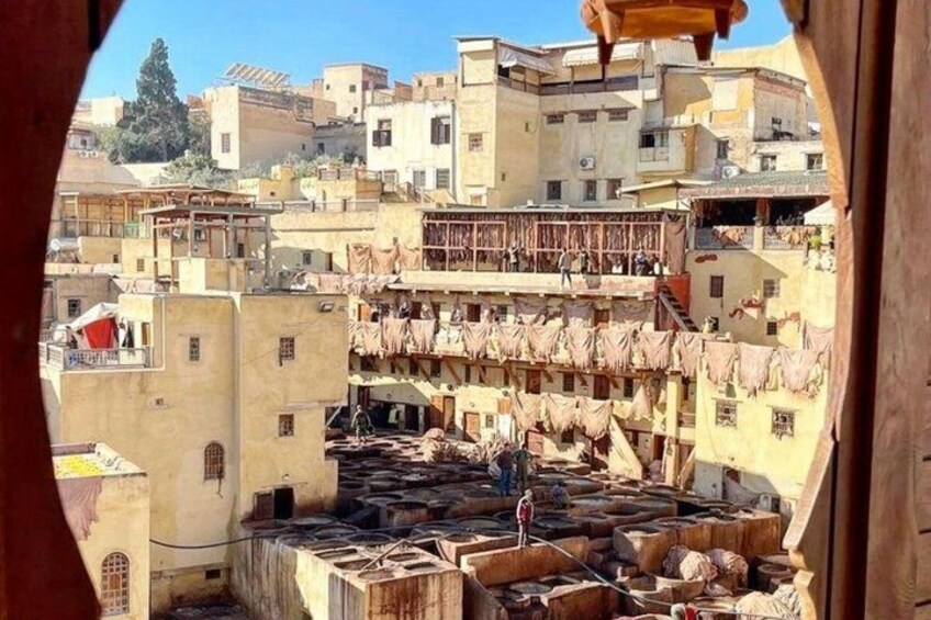 A traditional market with terracotta rooftops and a person standing in the center. 5