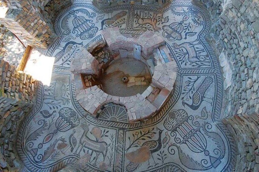 A circular stone structure with intricate carvings and a central open space. 5